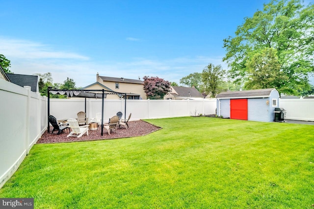 view of yard with a storage unit, an outbuilding, a fire pit, and a pergola