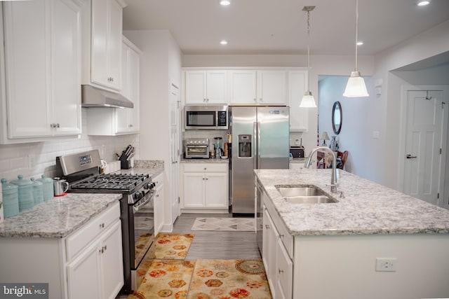 8212 Hickory Hollow Dr, Glen Burnie, MD 21060 - kitchen featuring appliances with stainless steel finishes, a sink, under cabinet range hood, white cabinets, and recessed lighting