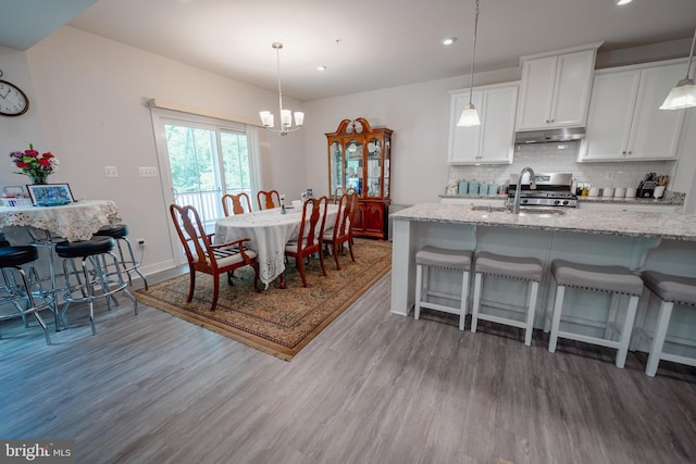 8212 Hickory Hollow Dr, Glen Burnie, MD 21060 - kitchen with a sink, light wood-style floors, backsplash, recessed lighting, and range