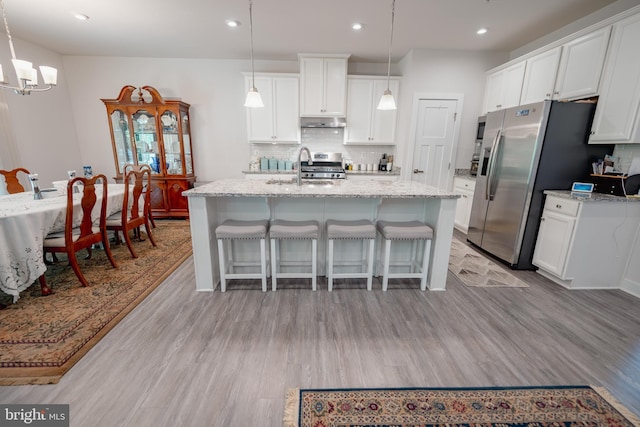 8212 Hickory Hollow Dr, Glen Burnie, MD 21060 - kitchen with range, under cabinet range hood, recessed lighting, decorative backsplash, and light wood-type flooring