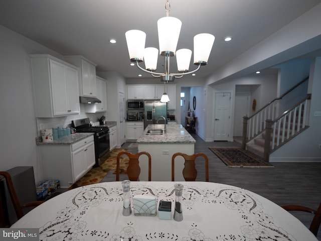 8212 Hickory Hollow Dr, Glen Burnie, MD 21060 - kitchen with appliances with stainless steel finishes, a sink, under cabinet range hood, white cabinetry, and recessed lighting