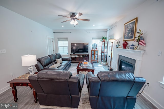 8212 Hickory Hollow Dr, Glen Burnie, MD 21060 - living room with wood finished floors, baseboards, ceiling fan, a glass covered fireplace, and recessed lighting