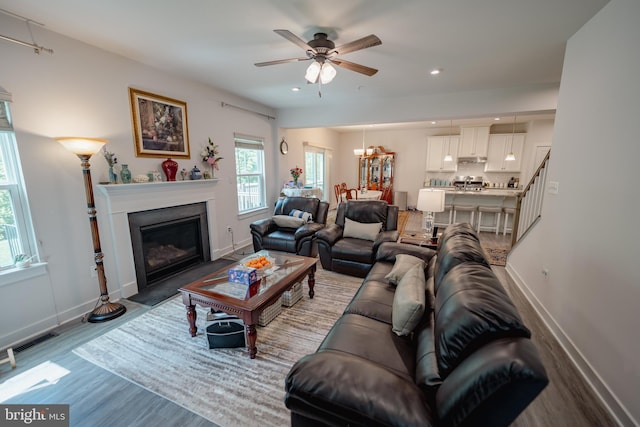 8212 Hickory Hollow Dr, Glen Burnie, MD 21060 - living room featuring wood finished floors, ceiling fan, baseboards, a fireplace with flush hearth, and recessed lighting