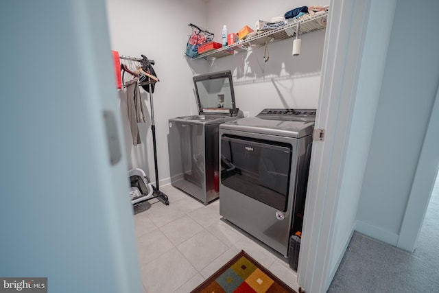 8212 Hickory Hollow Dr, Glen Burnie, MD 21060 - laundry room featuring washing machine and dryer and light tile patterned floors