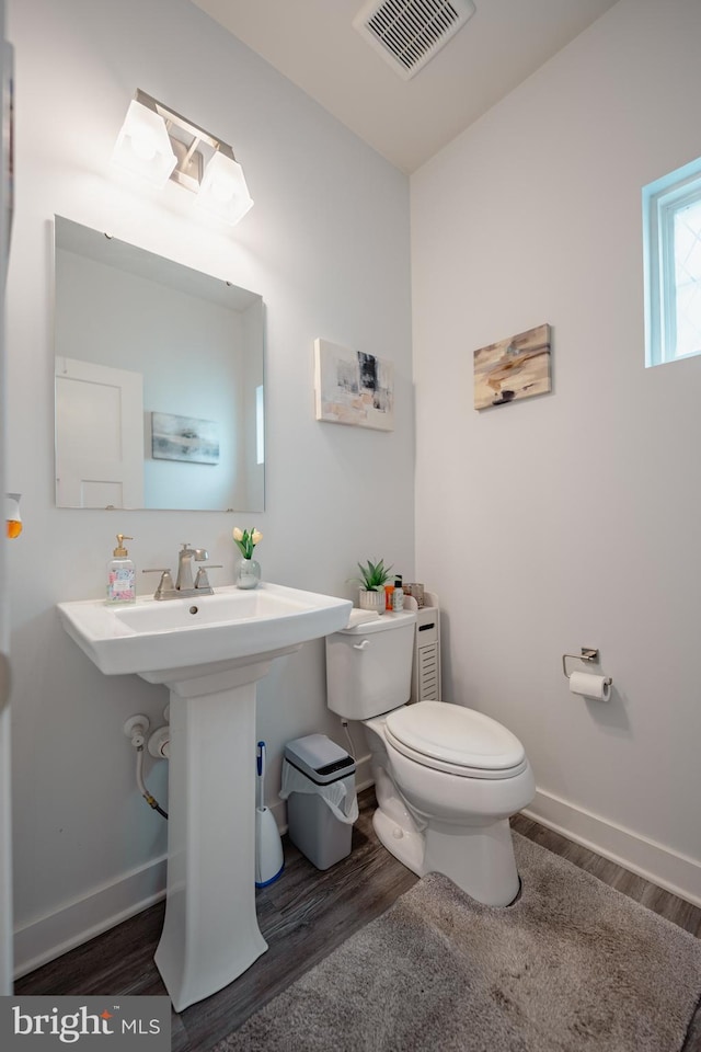 8212 Hickory Hollow Dr, Glen Burnie, MD 21060 - bathroom featuring wood finished floors, toilet, and baseboards