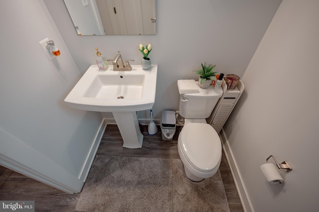 8212 Hickory Hollow Dr, Glen Burnie, MD 21060 - half bathroom featuring baseboards, toilet, and wood finished floors