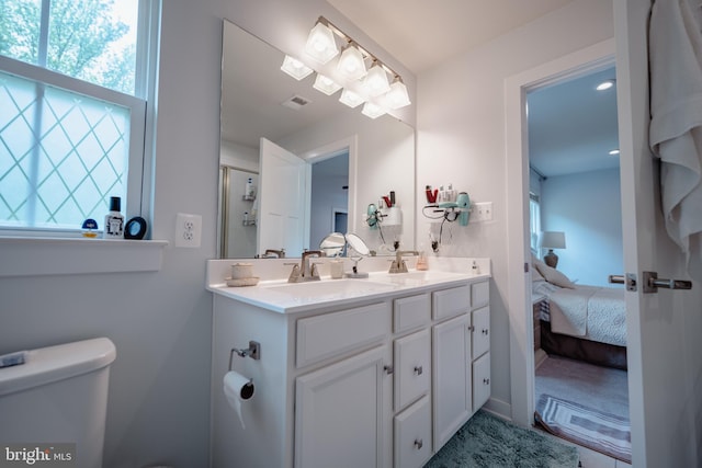 8212 Hickory Hollow Dr, Glen Burnie, MD 21060 - ensuite bathroom featuring plenty of natural light, double vanity, toilet, and a shower with shower door