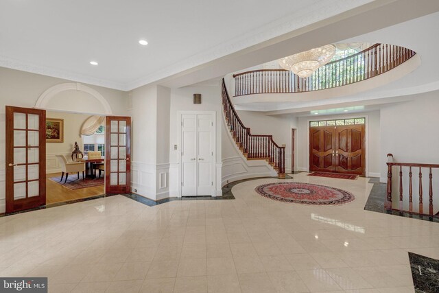 entryway with recessed lighting, stairway, a chandelier, french doors, and inlaid floor details