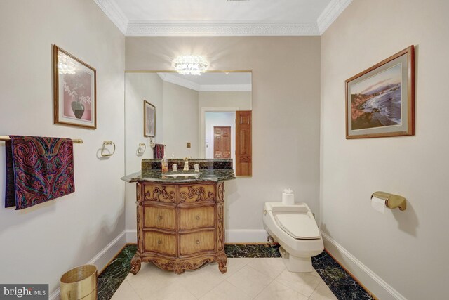 bathroom with crown molding, baseboards, toilet, tile patterned flooring, and vanity