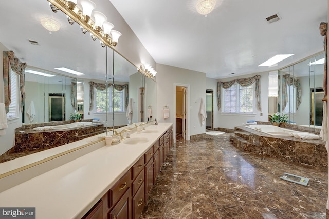 bathroom featuring marble tiled floors, a shower stall, plenty of natural light, and a bath