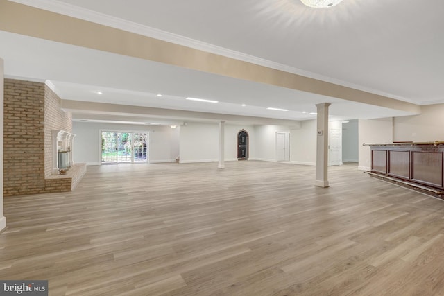 basement featuring recessed lighting, light wood-type flooring, baseboards, and crown molding