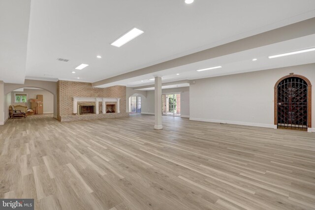 unfurnished living room with light wood finished floors, baseboards, recessed lighting, and healthy amount of natural light