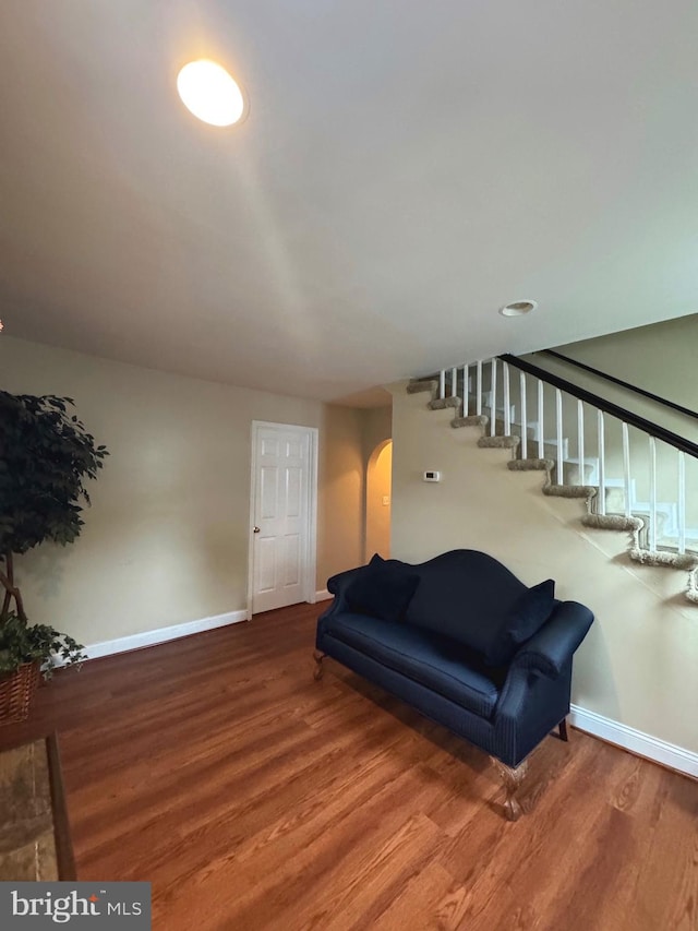707 Mentor Ave, Capitol Heights, MD 20743 - living area featuring arched walkways, wood finished floors, baseboards, and stairway