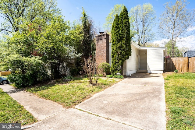view of front of house with driveway and a chimney