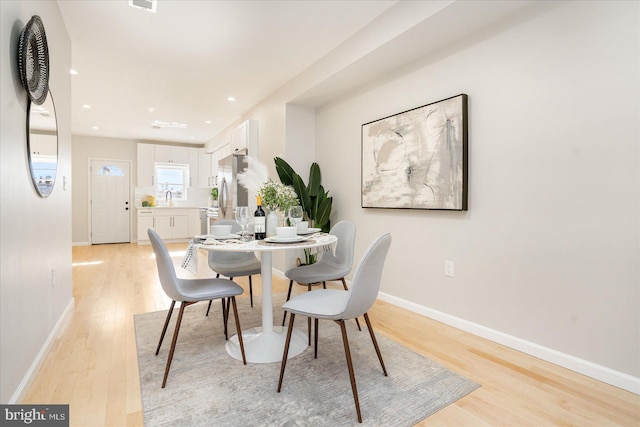 1413 E Lafayette Ave, Baltimore, MD 21213 - dining space with light wood-style flooring, baseboards, and recessed lighting