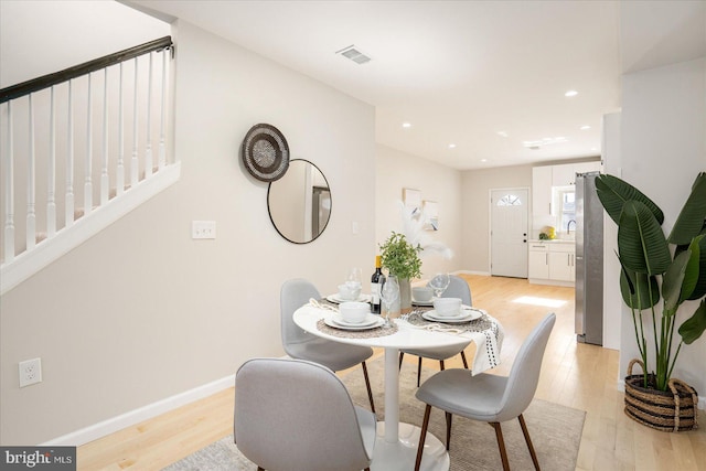 1413 E Lafayette Ave, Baltimore, MD 21213 - dining area with light wood-style flooring, baseboards, stairs, and recessed lighting