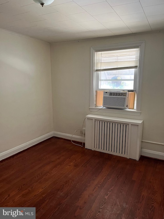 437 52nd St, Baltimore, MD 21224 - unfurnished room with radiator heating unit, cooling unit, dark wood-style floors, and baseboards