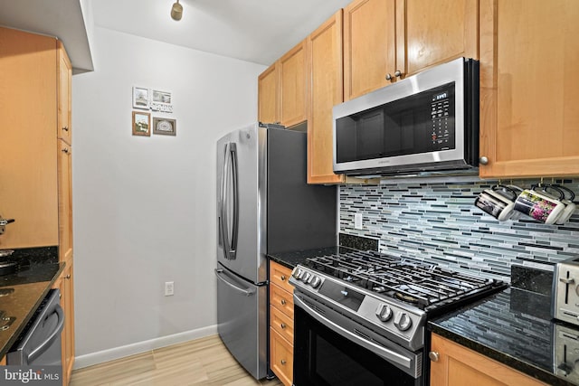 851 N Glebe Rd Unit 406, Arlington, VA 22203 - kitchen with appliances with stainless steel finishes, decorative backsplash, light wood-type flooring, baseboards, and dark stone countertops