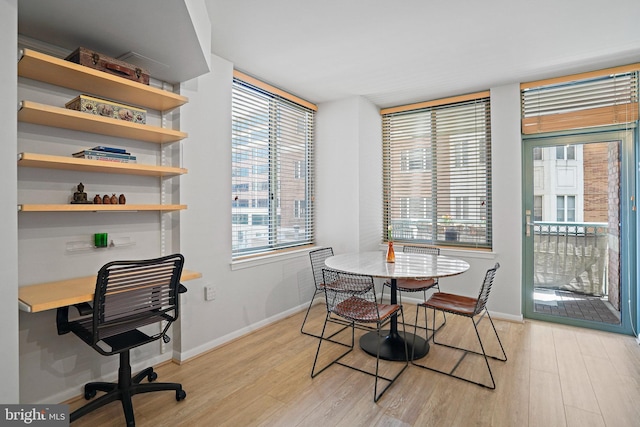 851 N Glebe Rd Unit 406, Arlington, VA 22203 - dining space with light wood-style flooring, plenty of natural light, baseboards, and an office area