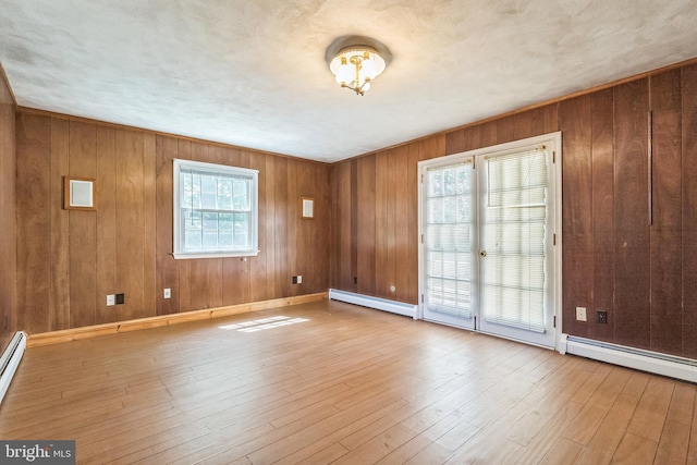 800 Little Shiloh Rd, West Chester, PA 19382 - empty room featuring baseboard heating, wood finished floors, wood walls, and baseboards