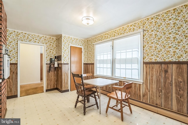 800 Little Shiloh Rd, West Chester, PA 19382 - dining room featuring a wainscoted wall, light flooring, wallpapered walls, a baseboard heating unit, and wood walls