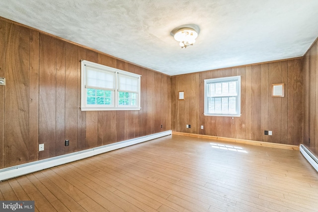 800 Little Shiloh Rd, West Chester, PA 19382 - unfurnished room with a baseboard heating unit, healthy amount of natural light, hardwood / wood-style flooring, and wooden walls