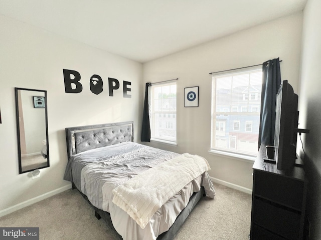carpeted bedroom featuring baseboards