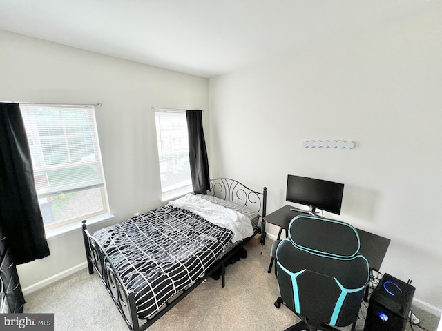bedroom featuring baseboards and carpet floors