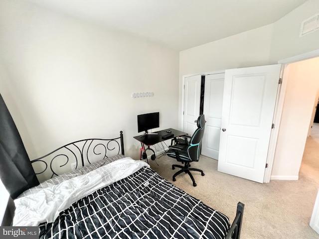bedroom with carpet floors, a closet, lofted ceiling, and baseboards