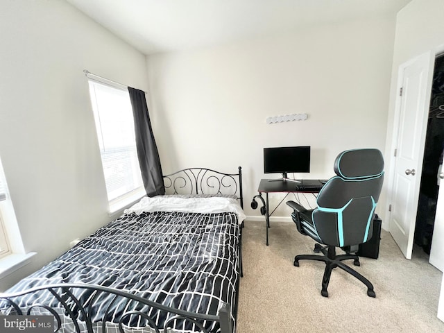 bedroom with carpet flooring, baseboards, and an office area