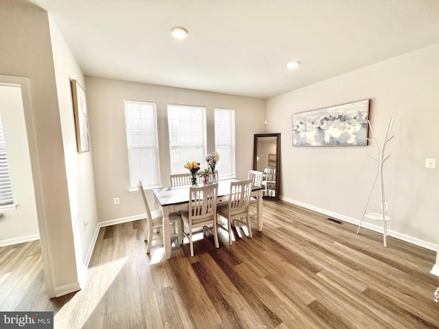 dining area with wood finished floors, baseboards, and recessed lighting