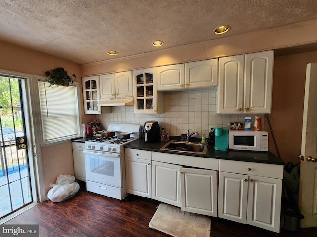 1351 Cambria St, Baltimore, MD 21225 - kitchen with white appliances, a sink, dark countertops, a textured ceiling, and under cabinet range hood