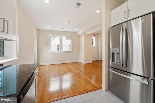 1706 Otis St NE, Washington, DC 20018 - kitchen with appliances with stainless steel finishes, dark stone counters, white cabinets, a chandelier, and recessed lighting