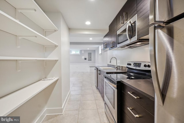 1706 Otis St NE, Washington, DC 20018 - kitchen featuring stainless steel appliances, a sink, dark brown cabinets, light tile patterned floors, and recessed lighting