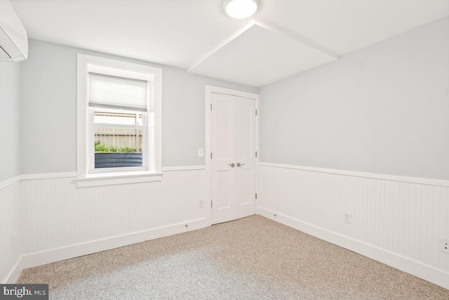 1706 Otis St NE, Washington, DC 20018 - carpeted empty room featuring a wall mounted air conditioner and a wainscoted wall