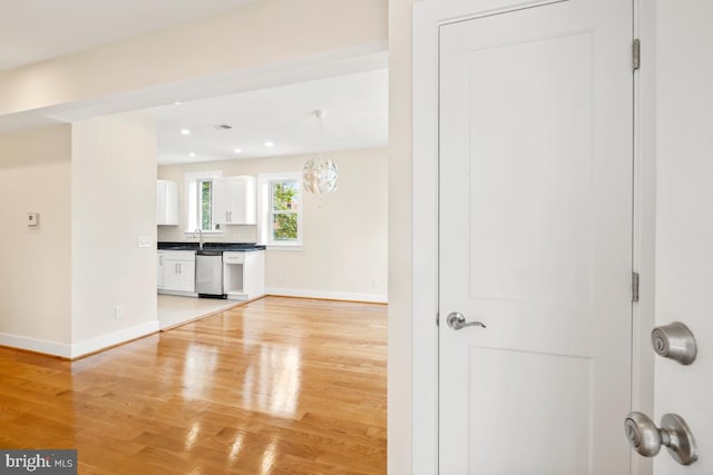 1706 Otis St NE, Washington, DC 20018 - unfurnished living room with light wood-style flooring, baseboards, recessed lighting, and a chandelier