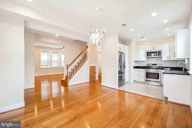1706 Otis St NE, Washington, DC 20018 - kitchen featuring stainless steel appliances, open floor plan, a sink, recessed lighting, and white cabinets