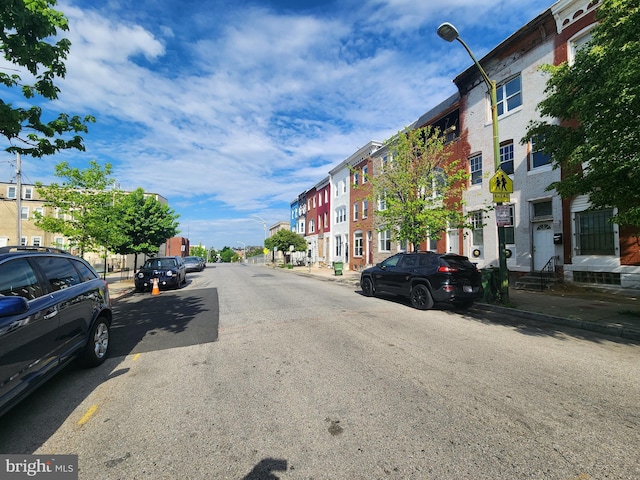 321 E 21st St, Baltimore, MD 21218 - view of asphalt street featuring street lighting, sidewalks, a residential view, and curbs