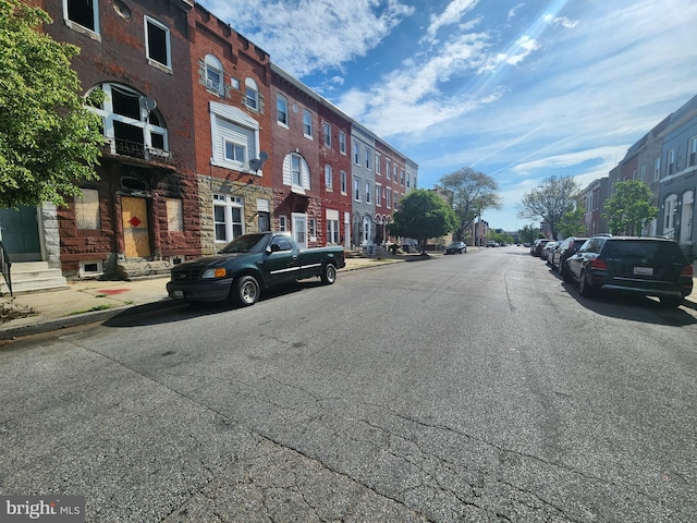 321 E 21st St, Baltimore, MD 21218 - view of asphalt road featuring curbs, sidewalks, and a residential view