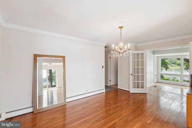 21821 Cove Ln, Leonardtown, MD 20650 - unfurnished room featuring a baseboard heating unit, crown molding, wood finished floors, a chandelier, and french doors