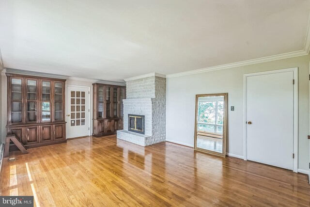 21821 Cove Ln, Leonardtown, MD 20650 - unfurnished living room featuring light wood finished floors, a fireplace, ornamental molding, and baseboards