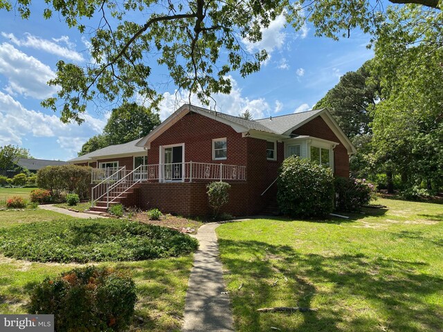 21821 Cove Ln, Leonardtown, MD 20650 - view of front of house featuring brick siding, a front yard, and stairway