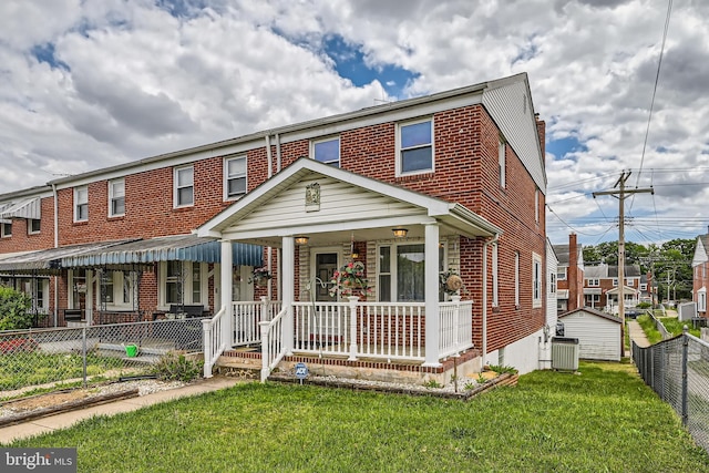 multi unit property featuring a porch, brick siding, and cooling unit