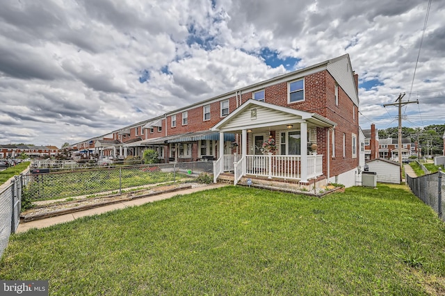 multi unit property with a porch, brick siding, and central AC