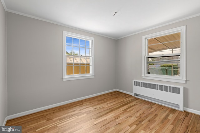 3142 Yorkway, Baltimore, MD 21222 - spare room featuring radiator heating unit, light wood-style floors, and crown molding