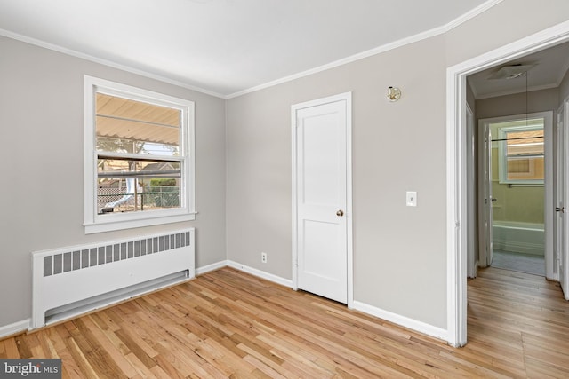3142 Yorkway, Baltimore, MD 21222 - unfurnished bedroom featuring radiator, light wood finished floors, crown molding, and attic access