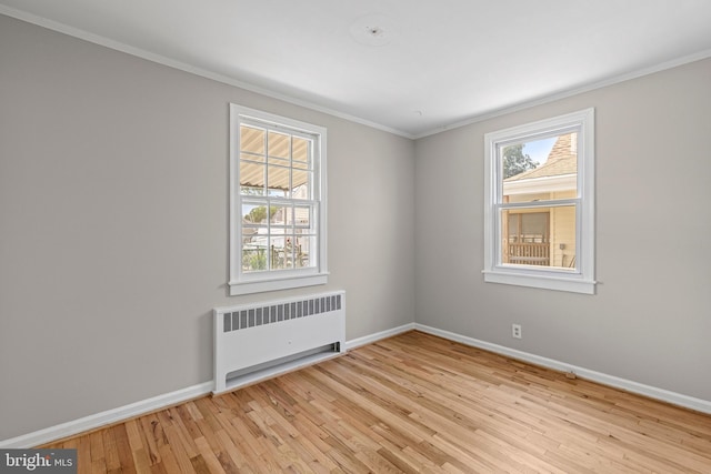 3142 Yorkway, Baltimore, MD 21222 - empty room featuring radiator, light wood-type flooring, and crown molding