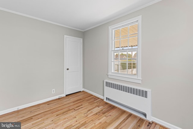 3142 Yorkway, Baltimore, MD 21222 - empty room featuring radiator, wood finished floors, and ornamental molding