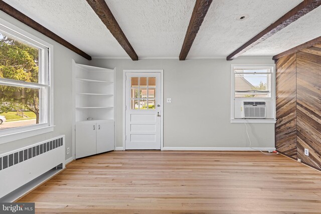 3142 Yorkway, Baltimore, MD 21222 - foyer entrance with radiator heating unit, beam ceiling, a textured ceiling, light wood-style floors, and cooling unit