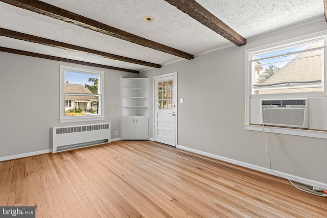 3142 Yorkway, Baltimore, MD 21222 - spare room featuring radiator, beamed ceiling, light wood finished floors, cooling unit, and a textured ceiling